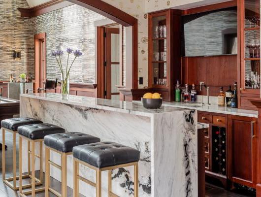 bar area with black cushioned stools